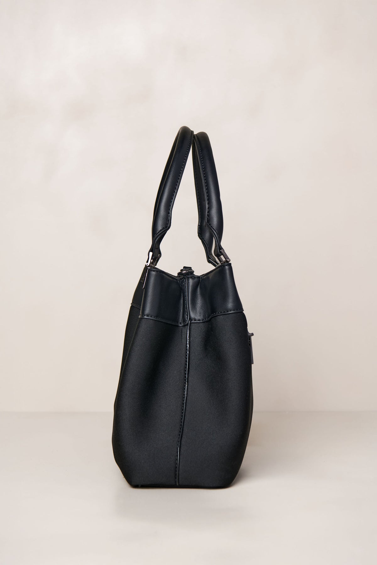 Black neoprene crossbody tote bag with handle and adjustable strap