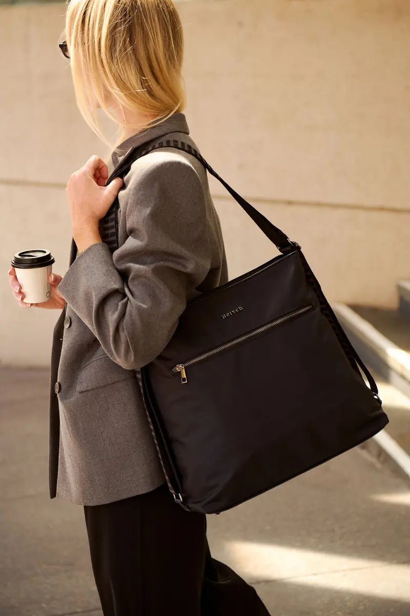 Black H-Convert carried as tote